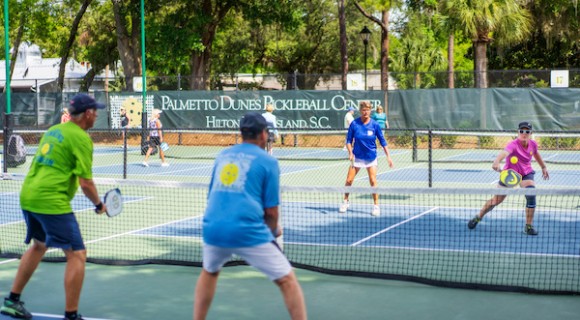 Sarah Ansboury in action with pickleball players at Palmetto Dunes Pickleball Center