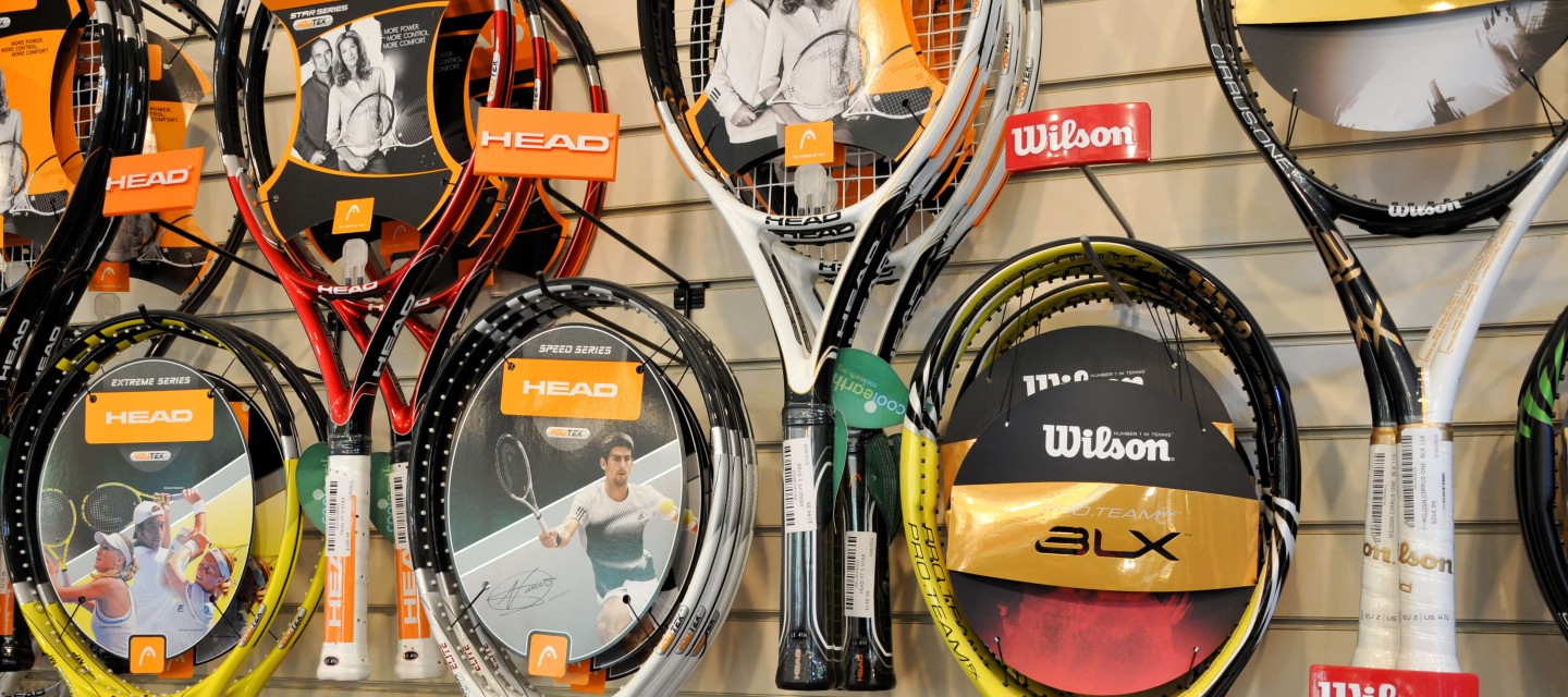 Wall display of tennis rackets at a pro shop