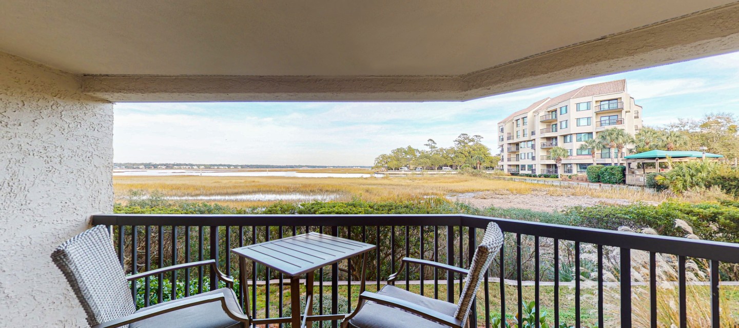 private balcony with two chairs overlooking expansive views of the marsh of a Hilton Head Island Vacation Rental
