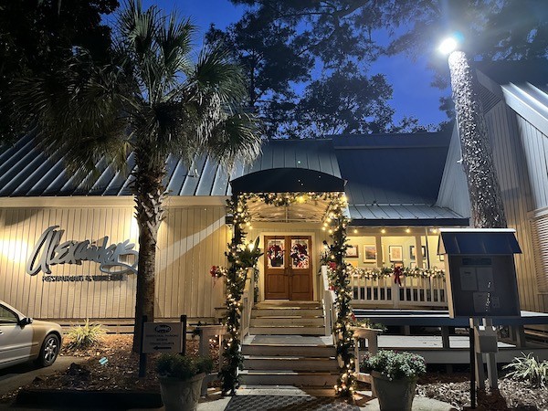 exterior of Alexander's Restaurant with holiday lights and decorations around then entrance