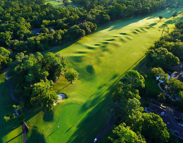 aerial view of hole 4 surrounded by tress of the Arthur Hills Golf Course