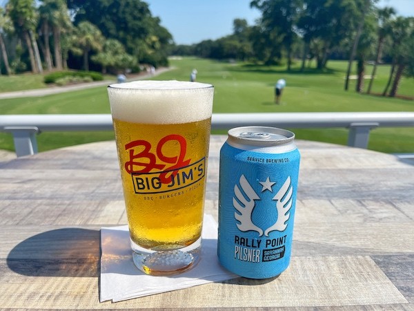 draft beer and a beer can on a table overlooking the golf course at Big Jim's