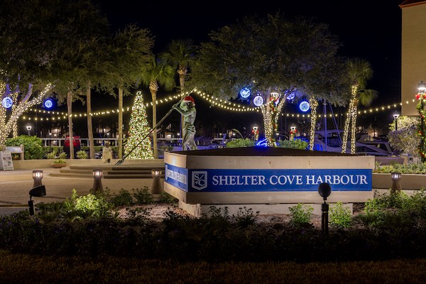 Shelter Cove Harbour statue with Christmas lights and decorations at night