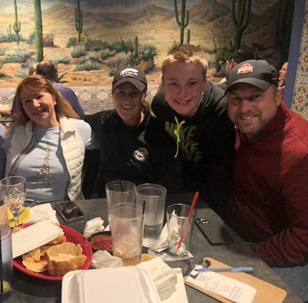 Dr. Yulia and Skylar with family at a restaurant