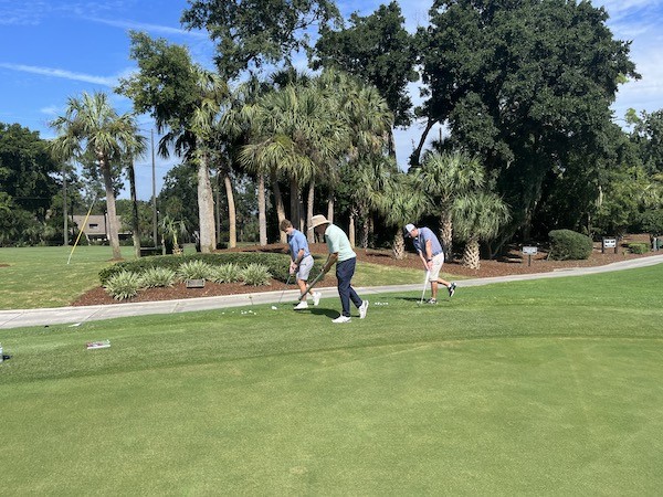 father and son practicing foot placement for chipping with Doug Weaver