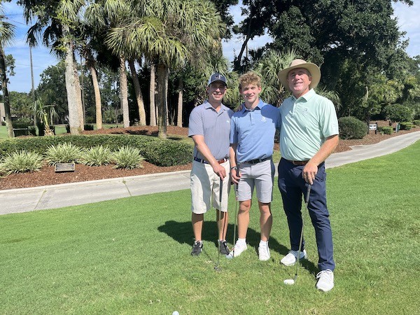 father and son with Doug Weaver during golf lessons at Palmetto Dunes