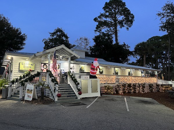 exterior of the Palmetto Dunes General Store at night with holiday lights and decorations