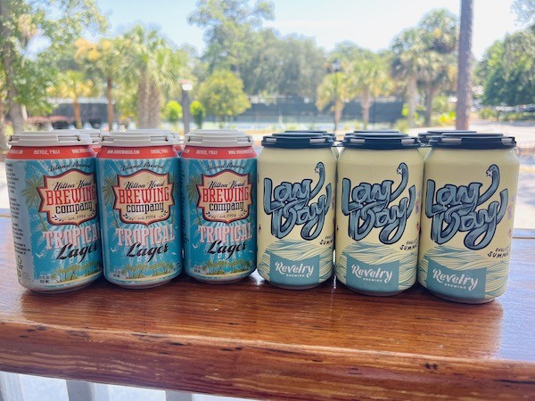 cans of Hilton Head Brewing Company Tropical Lager and Revelry Brewing Co. Lay Day Pale Ale