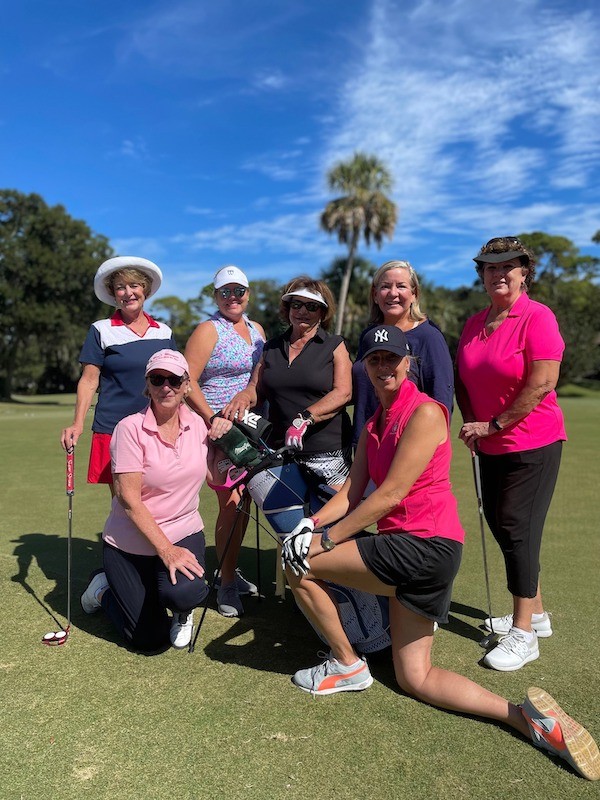 group of female golfers posing with golf clubs on the greens at Palmetto Dunes Oceanfront Resort