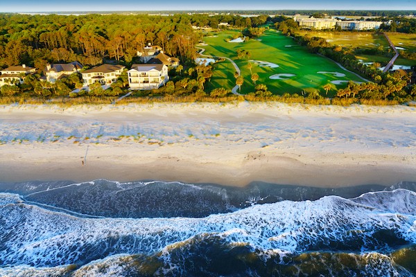 aerial view of Robert Trent Jones Hole 10 and the waves crashing on the beach