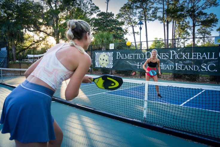 two women playing pickleball on the Palmetto Dunes Pickleball court