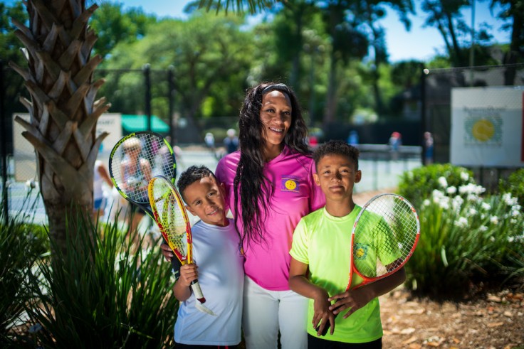 mom with two boys holding tennis rackets at Palmetto Dunes