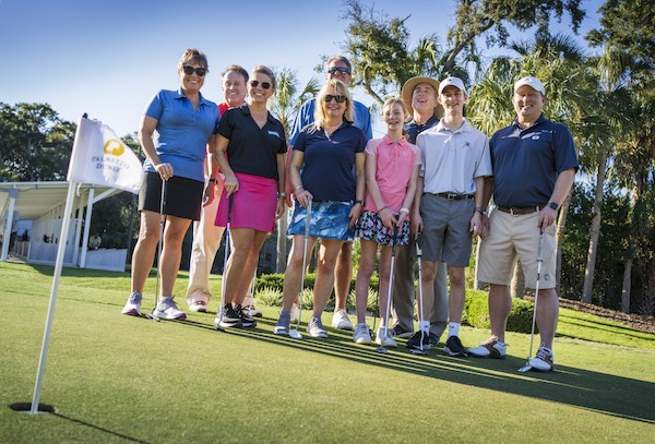 gourp of men and women posing with putters at Palmetto Dunes Golf Academy