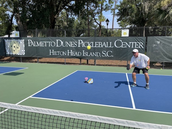 Purple the cat with a paddle playing Pickleball at the Palmetto Dune Pickleball Center