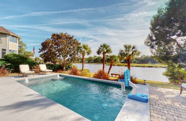 private pool with basketball hoop overlooking the lagoon and golf course at Palmetto Dunes
