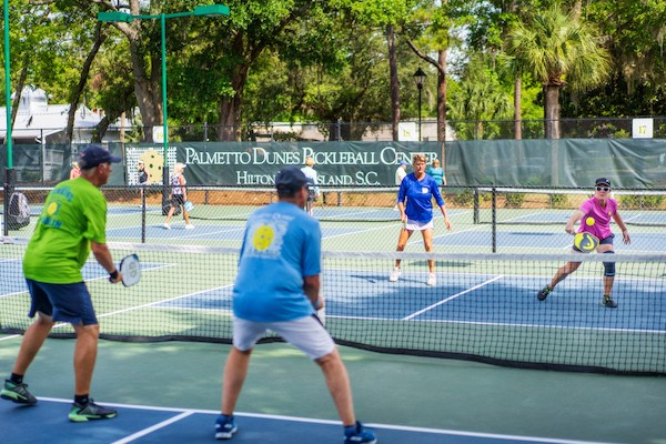 Sarah Ansboury in action with pickleball players at Palmetto Dunes Pickleball Center