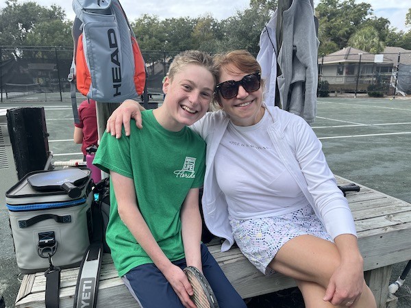 Skylar and Dr. Yulia posing on a bench on the Palmetto Dunes Tennis Courts