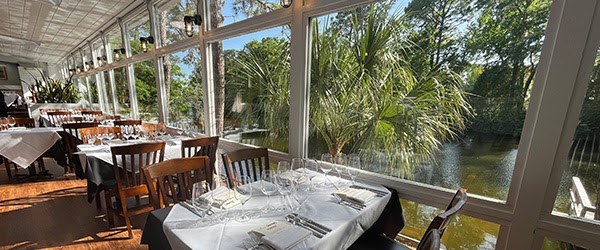 large windows overlooking the lagoon at Alexander's Restaurant in the sun room