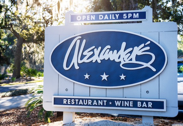 the Alexander's Restaurant & Wine Bar exterior sign with the sun shining in the background