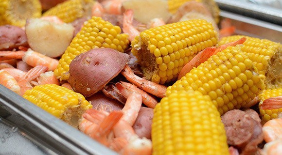 close up of potatoes, shrimp and corn