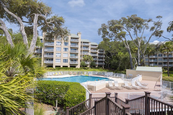 resort pool surrounded by trees and buildings of Barrington Arms