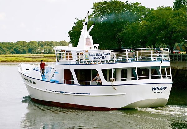 exterior shot of the Holiday dolphin cruise boat leaving the marina