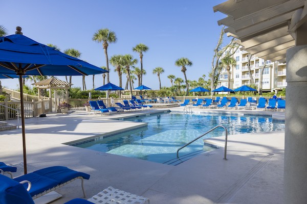 resort pool surrounded by blue lounge chairs at Hampton Place