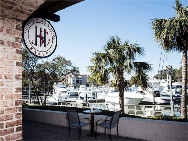 table and chairs overlooking marina of boats at Hilton Head Social Bakery