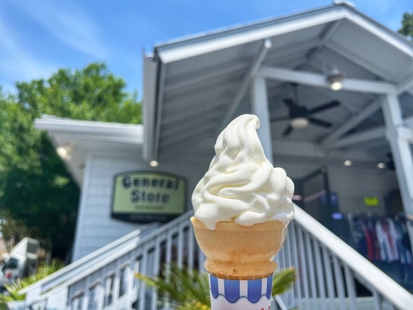 vanilla ice cream cone with the entrance of the General Store in the background