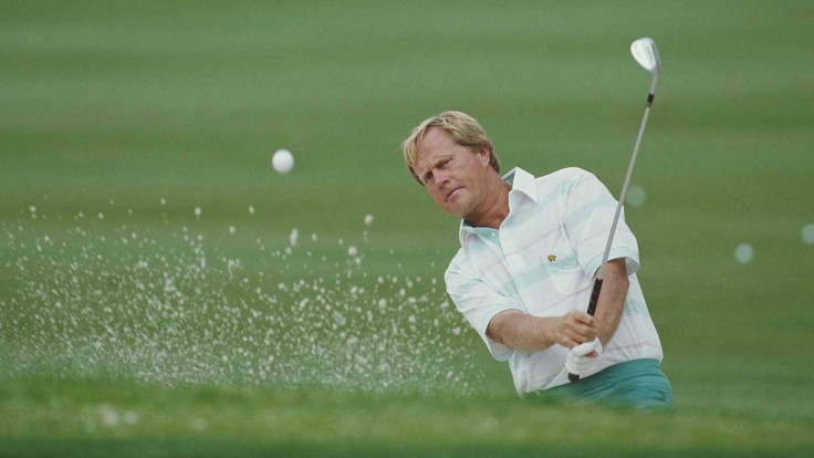 jack nicklaus watching golf ball fly in air along with sand
