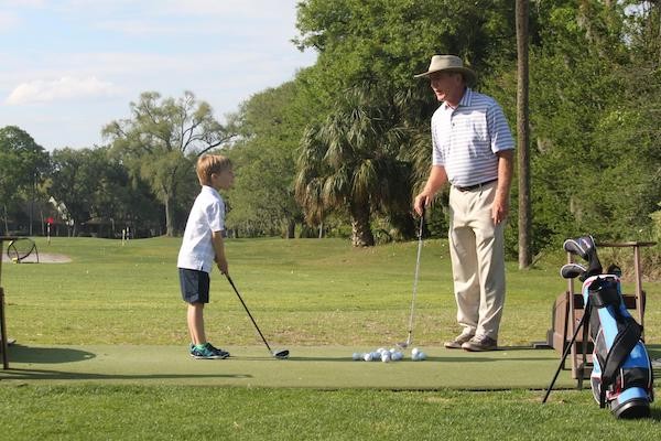 junior golfer taking lessons from Doug Weaver