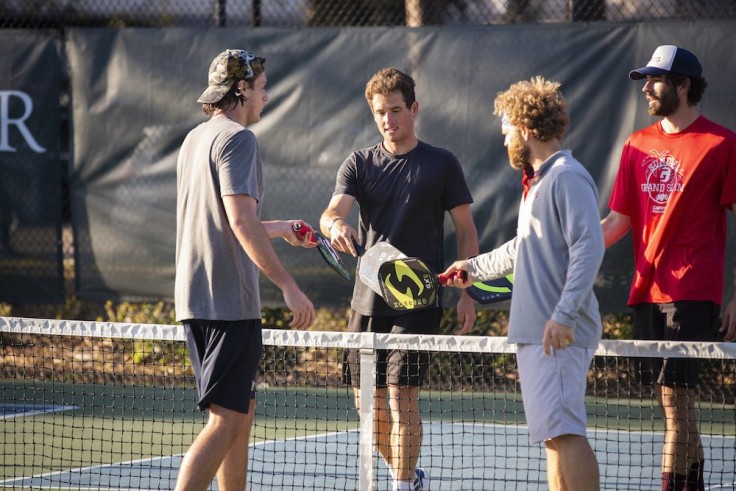 four male pickleball players huddling up after a pickleball game at Palmetto Dunes
