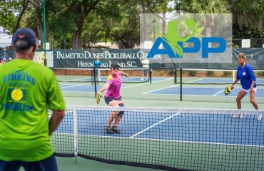 pickleball pros mid game at tournament held at Palmetto Dunes Pickleball Center