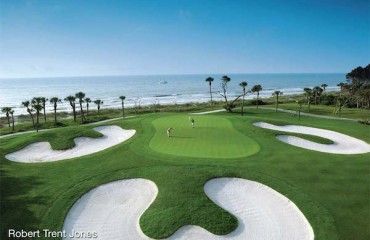aerial view of two golfers on robert trent jones course with ocean in the background