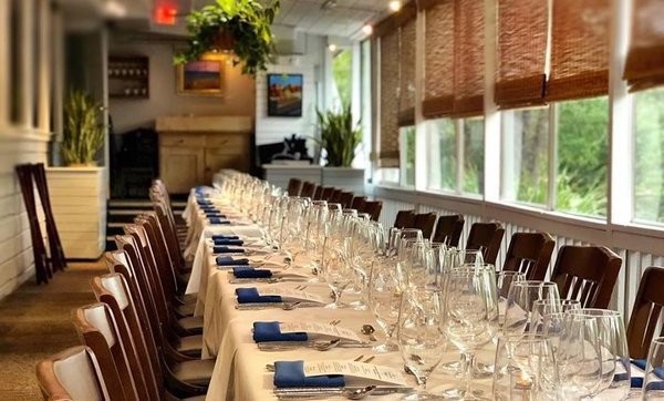 long table setup for wine dinner event in sunroom at alexander's restaurant