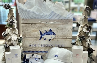 southern tide gift bag next to christmas trees with products