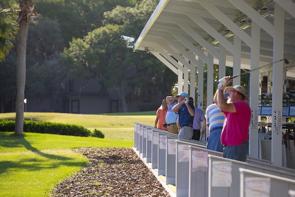 golfers mid swing at the Toptracer Golf Range