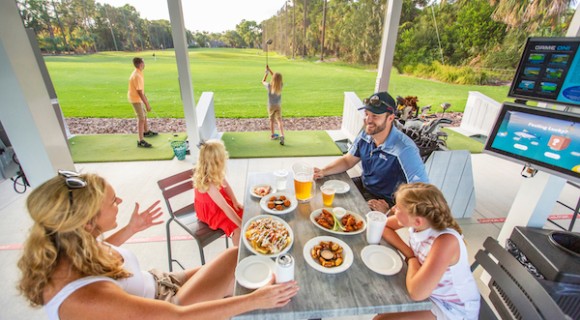 Family eating and playing at Toptracer Range