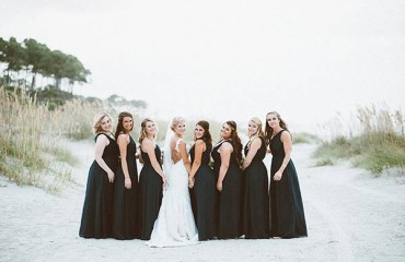 Bride and Bridesmaids posing in the dunes along the beach