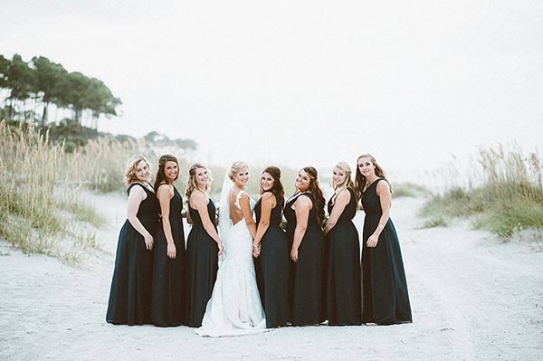 Bride and Bridesmaids posing in the dunes along the beach