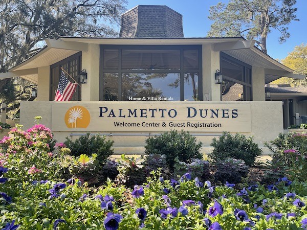 Palmetto Dunes Welcome Center front sign and entrance surrounded by flowers