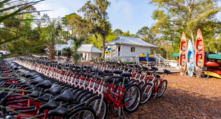 rows of red bikes and kayaks outside of hilton head outfitters