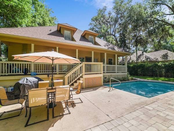 back porch and private pool with seating area of a Hilton Head Island vacation home