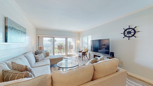 living room with nautical decorations with access to private oceanfront balcony of a Palmetto Dunes vacation home
