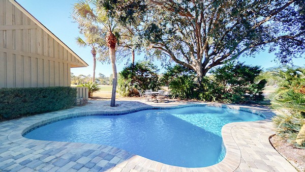 private pool and trees of a Palmetto Dunes vacation home