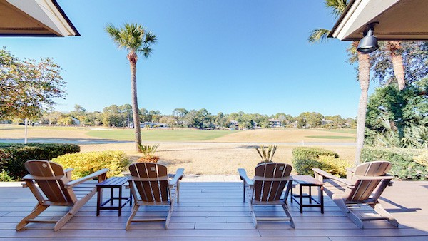 4 Adirondack chairs on a private deck of a Hilton Head vacation home overlooking the golf course