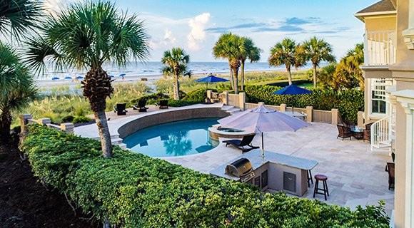 view of the backyard and private pool overlooking the dunes and ocean from a Palmetto Dunes Oceanfront vacation home