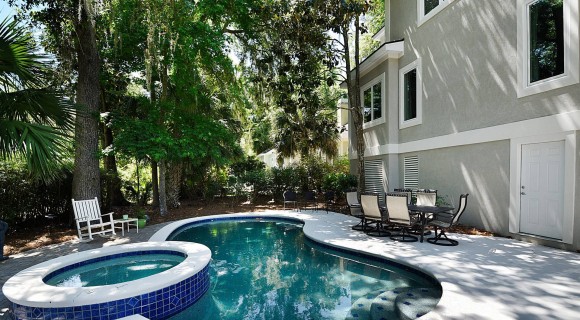 beautiful private pool with span and lush landscaping of Palmetto Dunes Vacation Rental