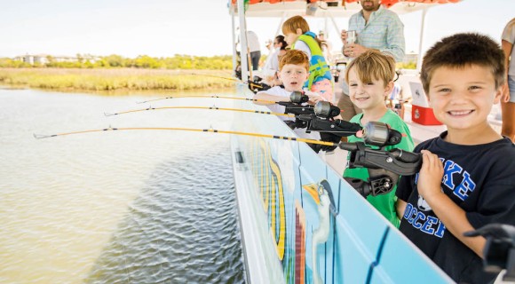 several boys fishing over the boat