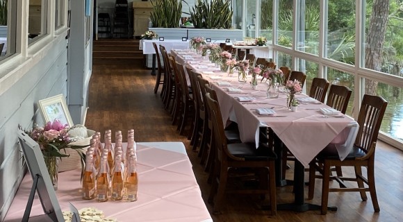 long table with pink tablecloth and flowers in Alexander's sunroom